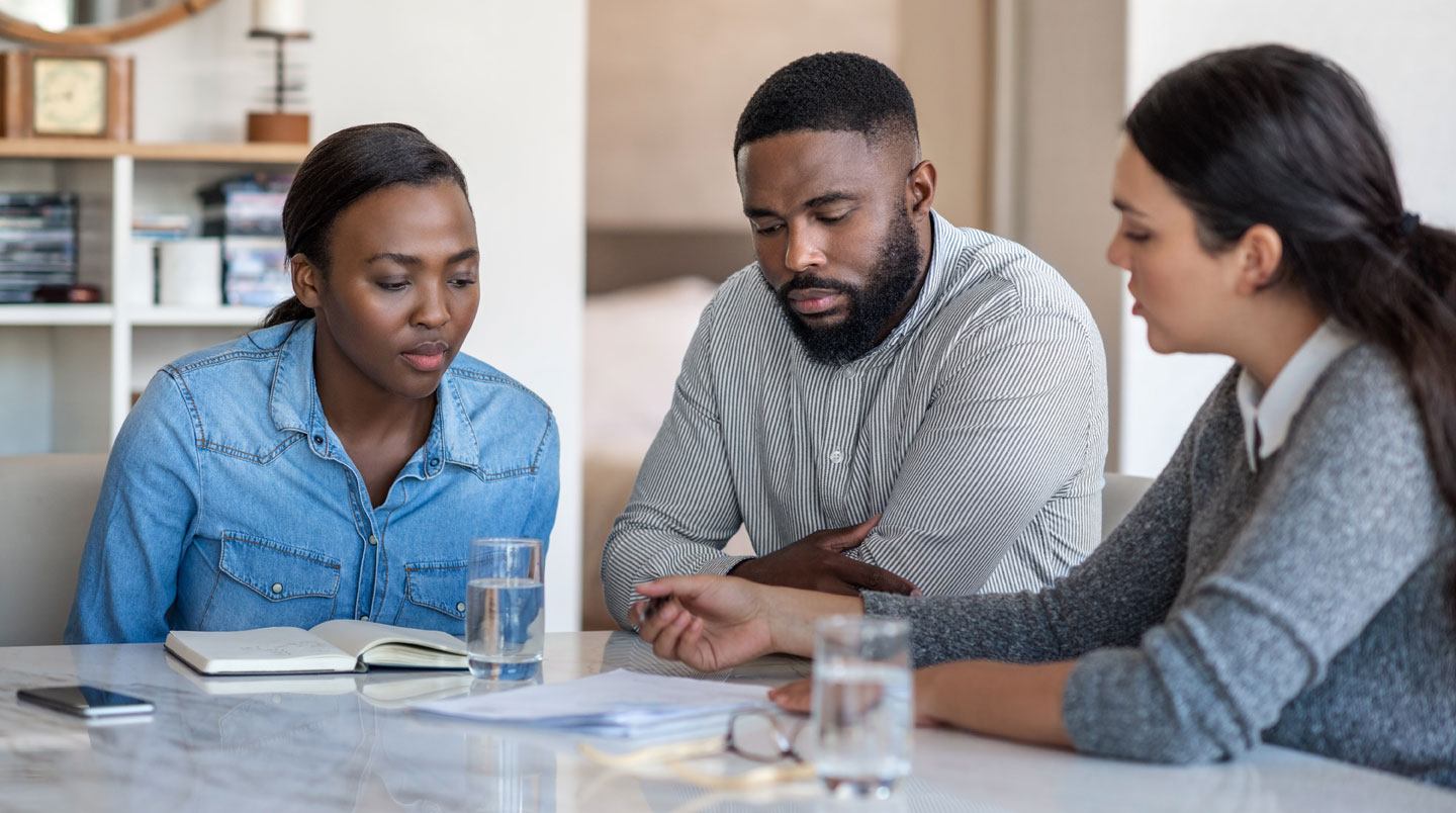 HR compliance specialist reviewing employment contracts and regulatory documentation for Nigeria, Kenya, and South Africa operations at office workstation